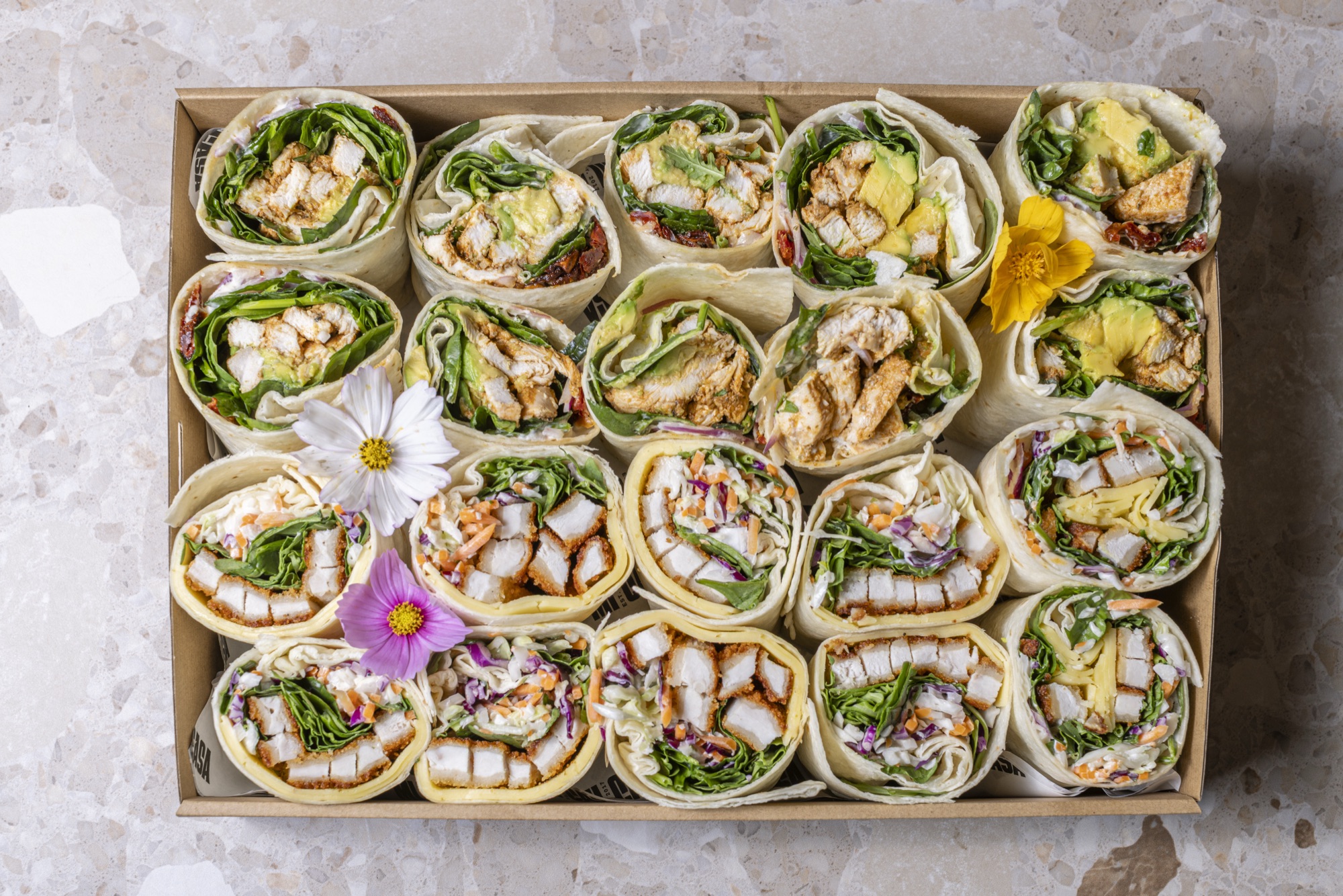 Wrap Box with rolled chicken wraps and greens